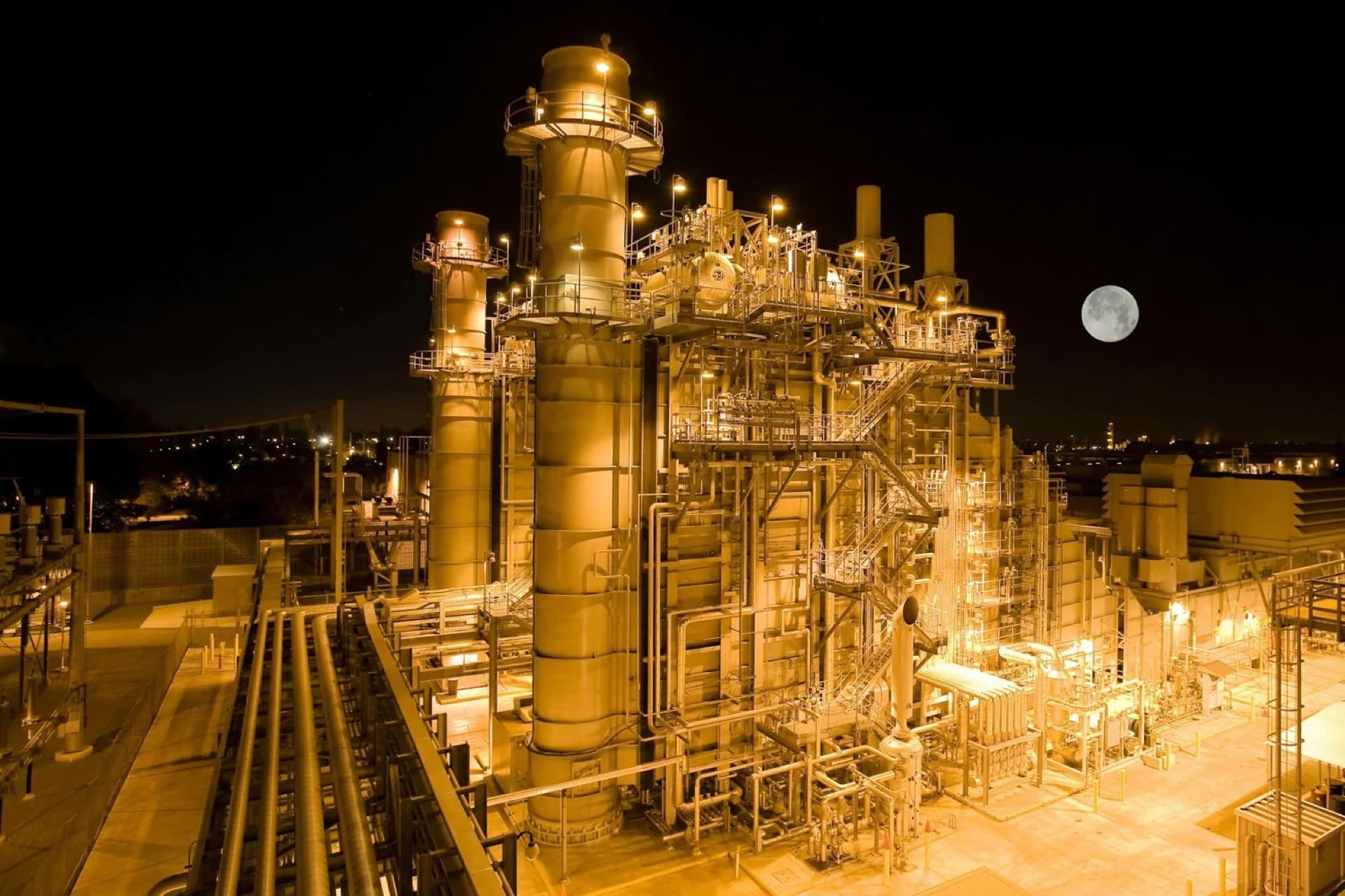 Power plant illuminated gold at night
