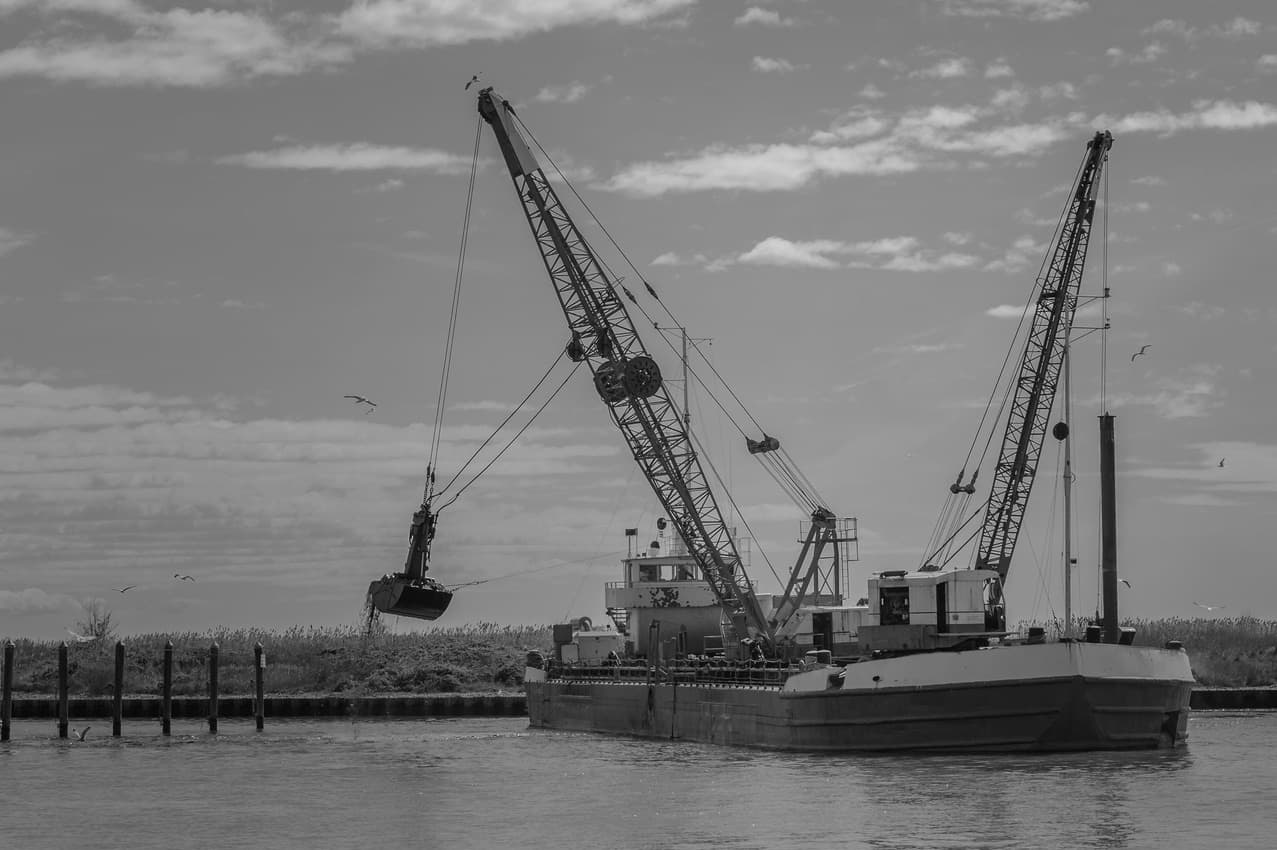 Crane barge working a coastal channel